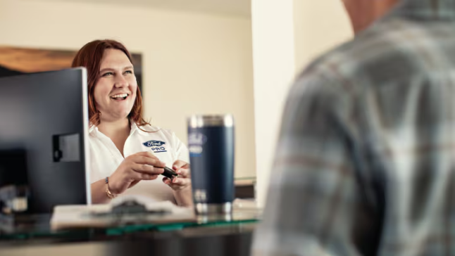 Trabajadora de Ford atendiendo un cliente