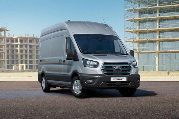 Un Ford E-Transit gris stationné sur une route.
