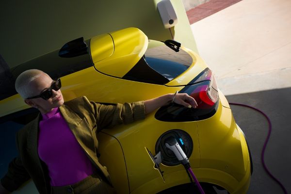 Frau lehnt sich gegen Ford Puma Gen-E, der aufgeladen wird
