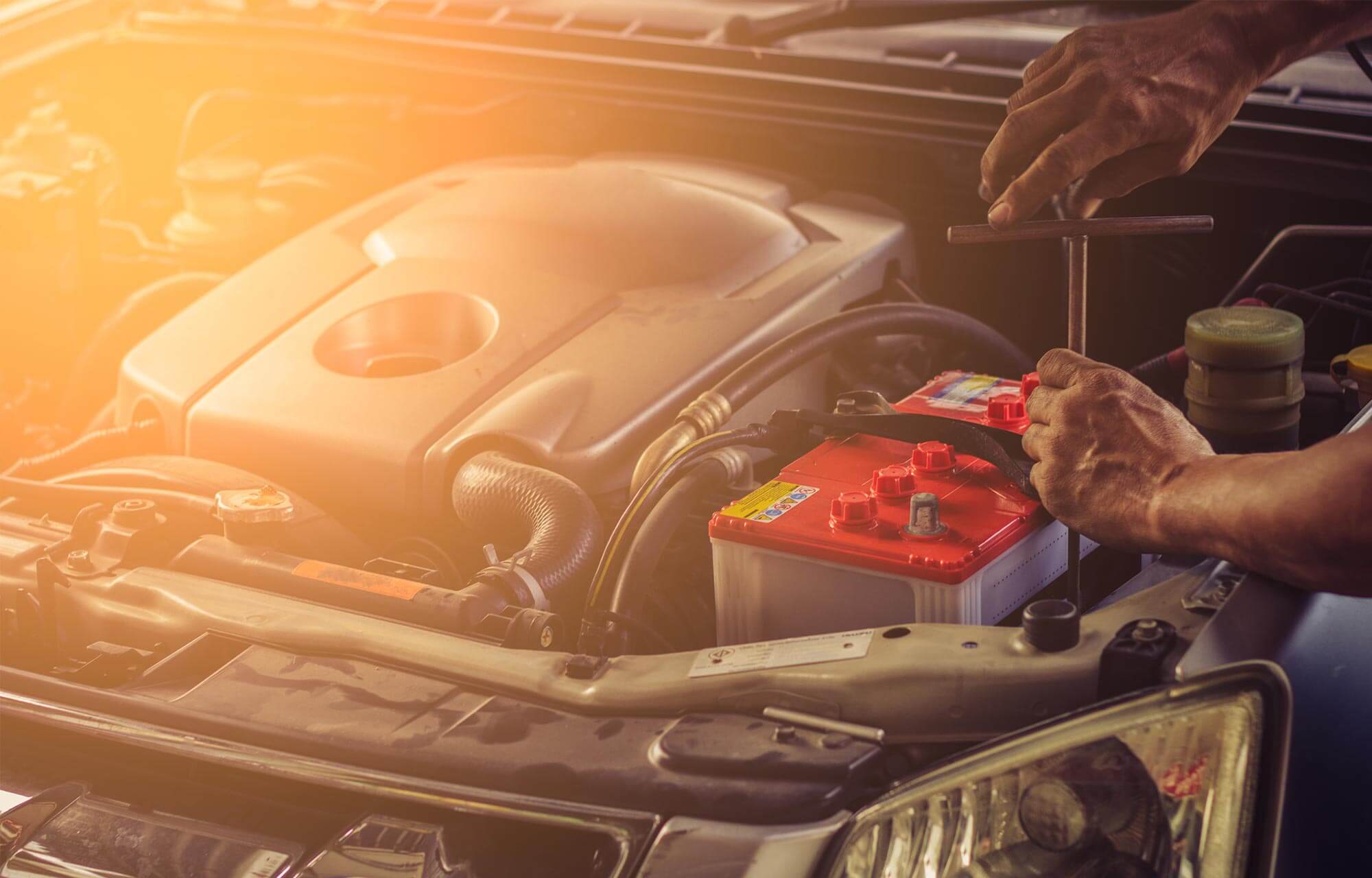 Mechanic working on car battery