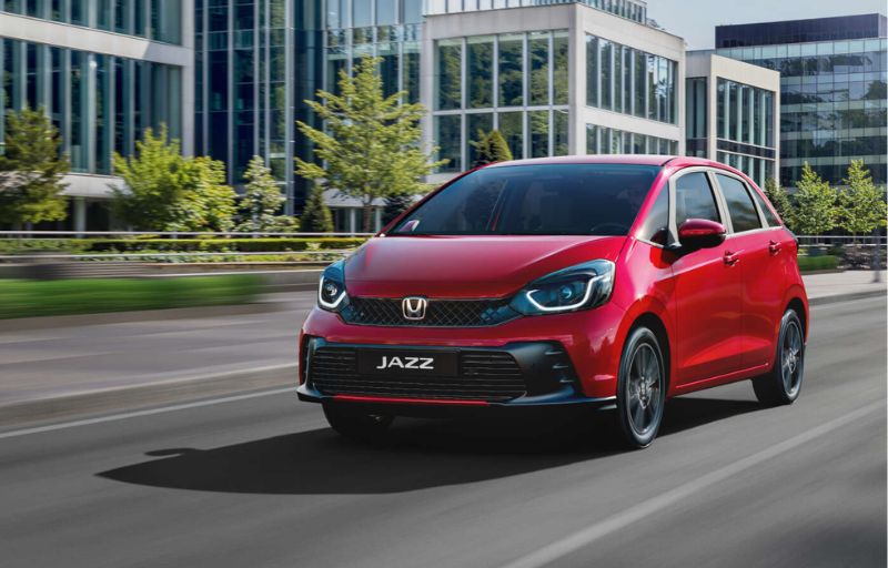 Red Honda Jazz on the road