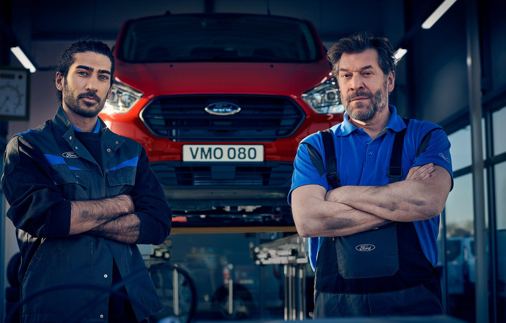 2 menn foran rød varebil