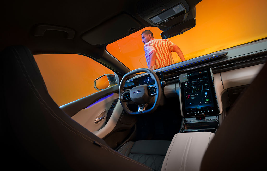 Interior shot of the All-Electric Capri showing the driver’s seat and central touchscreen