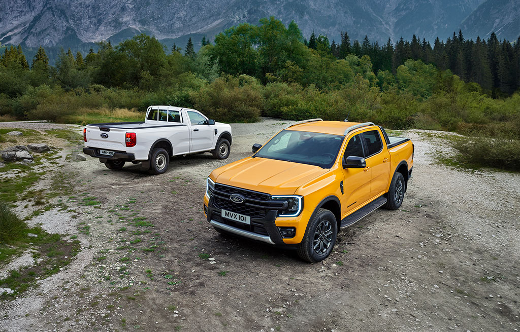 Ford Ranger pickup lineup driving through rugged mountain terrain outdoors