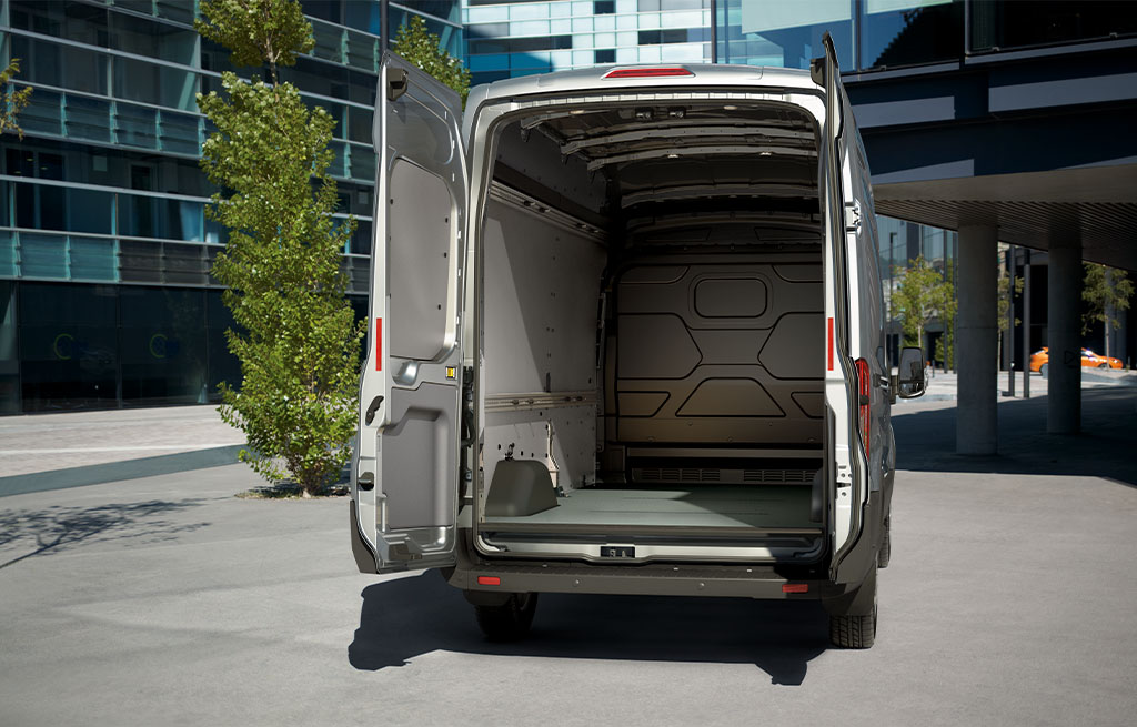 Rear view of a Ford Transit cargo van with open back doors showing spacious empty load area