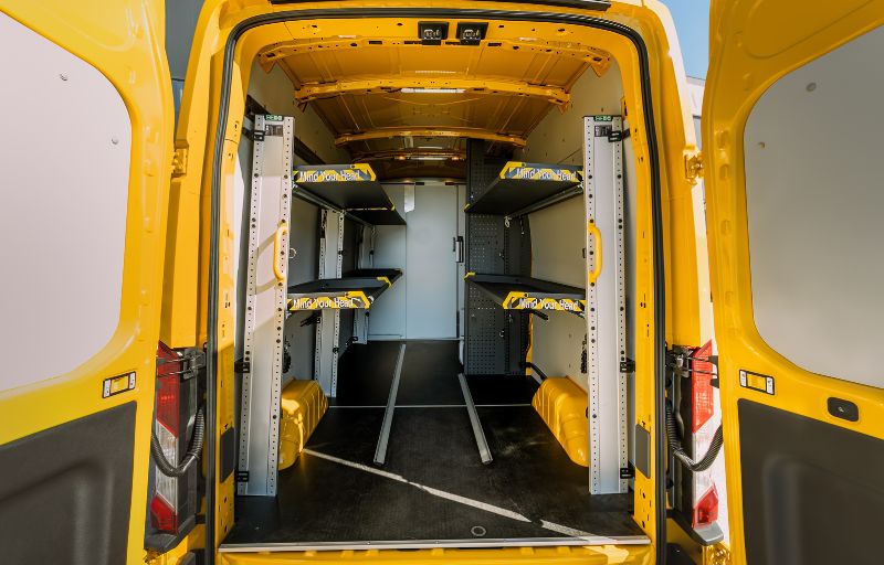 Lasterom med hyllesystem og oppbevaringsløsninger i DHL Ford Transit varebil