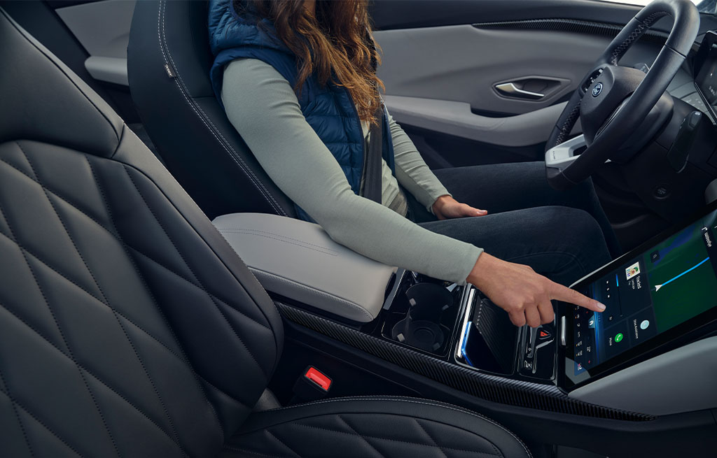 A woman sits in the driver’s seat of an All-Electric Explorer