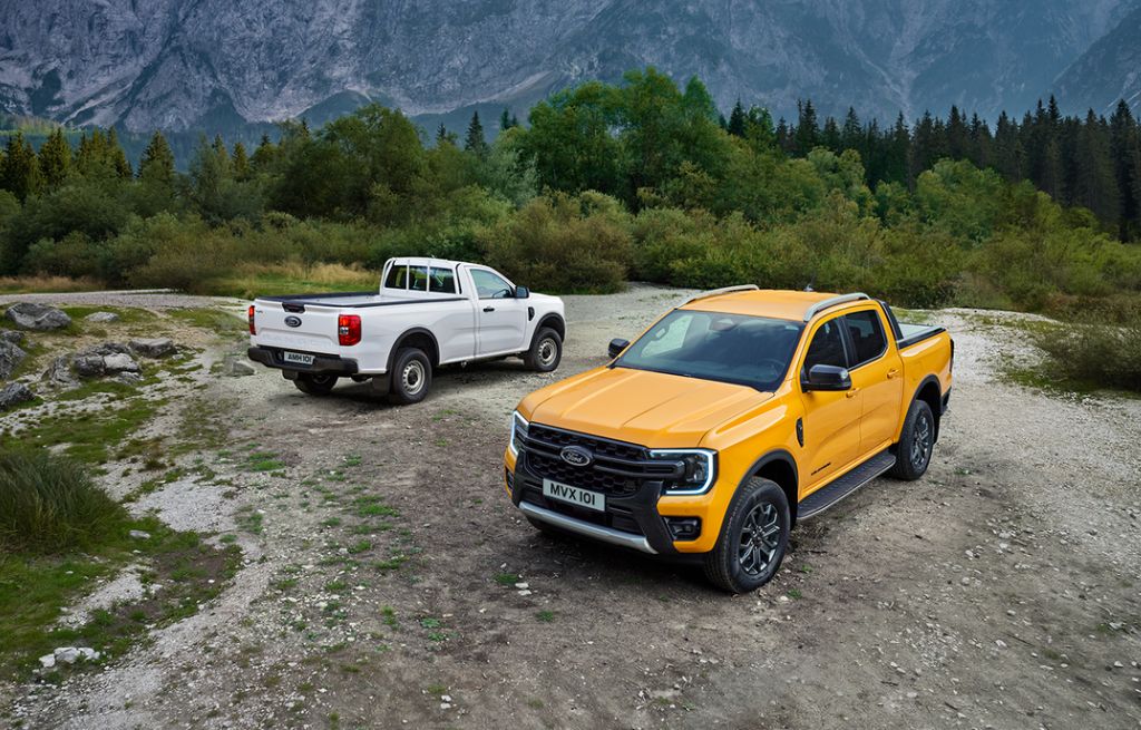 Yellow and white Ford Rangers parked off-road on rugged terrain