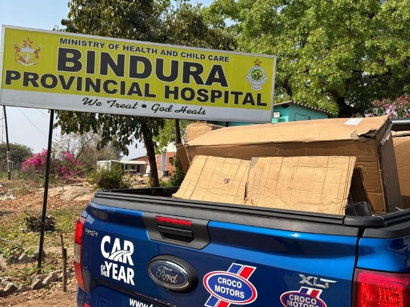 Truck in front of hospital truck with boxes in front of hospital